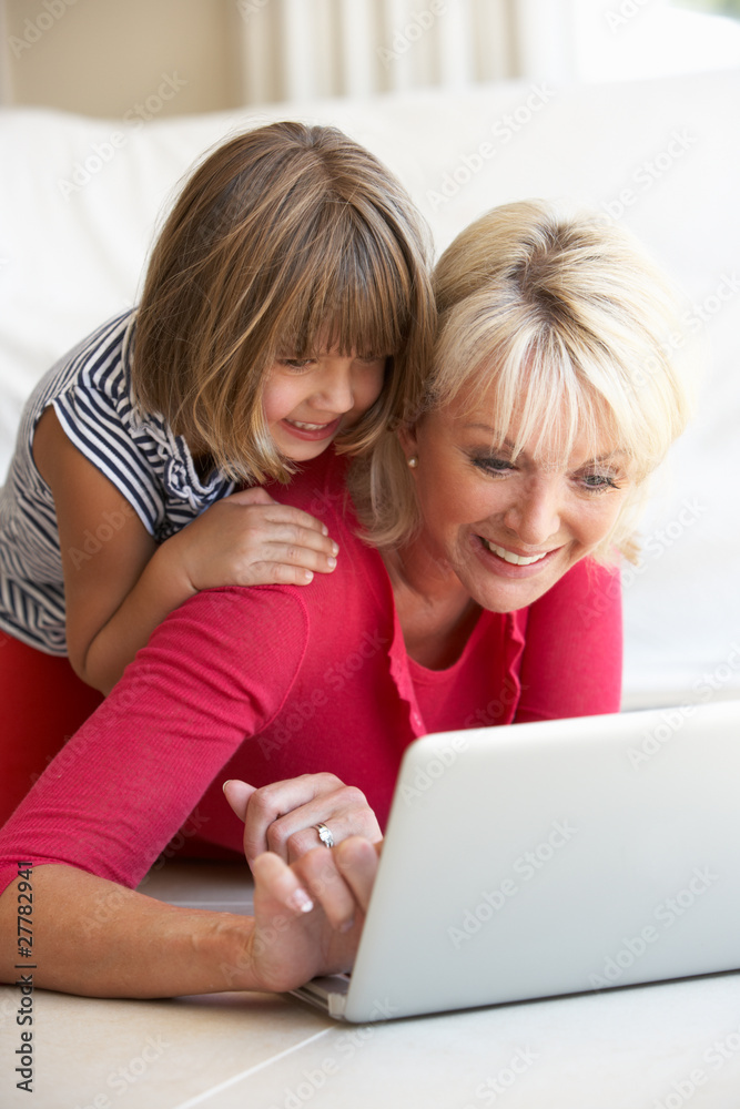 Middle age woman with young girl using laptop computer Middle age woman with young girl using laptop computer