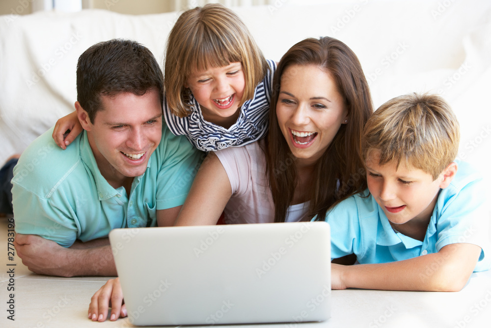 Young parents, with children, on laptop computer Young parents, with children, on laptop computer