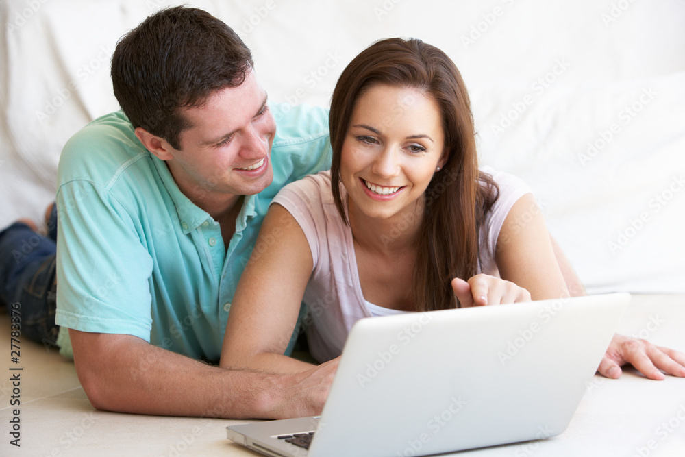 Young couple on laptop computer Young couple on laptop computer