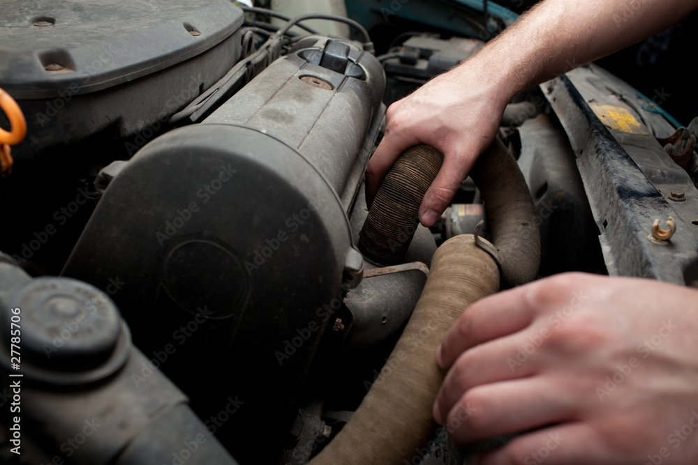 Fototapeta premium Closeup of mechanic repairing car