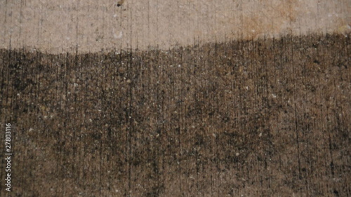 Pressure cleaning a dirty old driveway - close-up