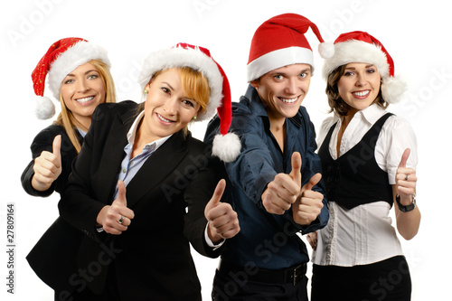 Four young and smart business persons in Christmas hats