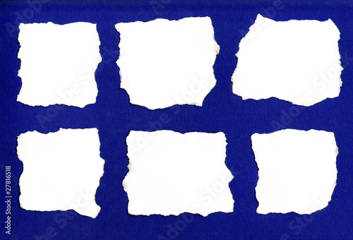White paper tears isolated on blue background