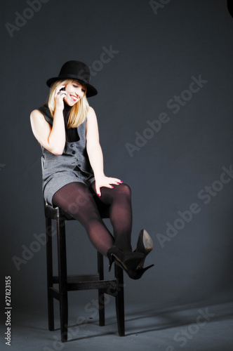 Beautiful blonde woman with hat talking on her cell phone