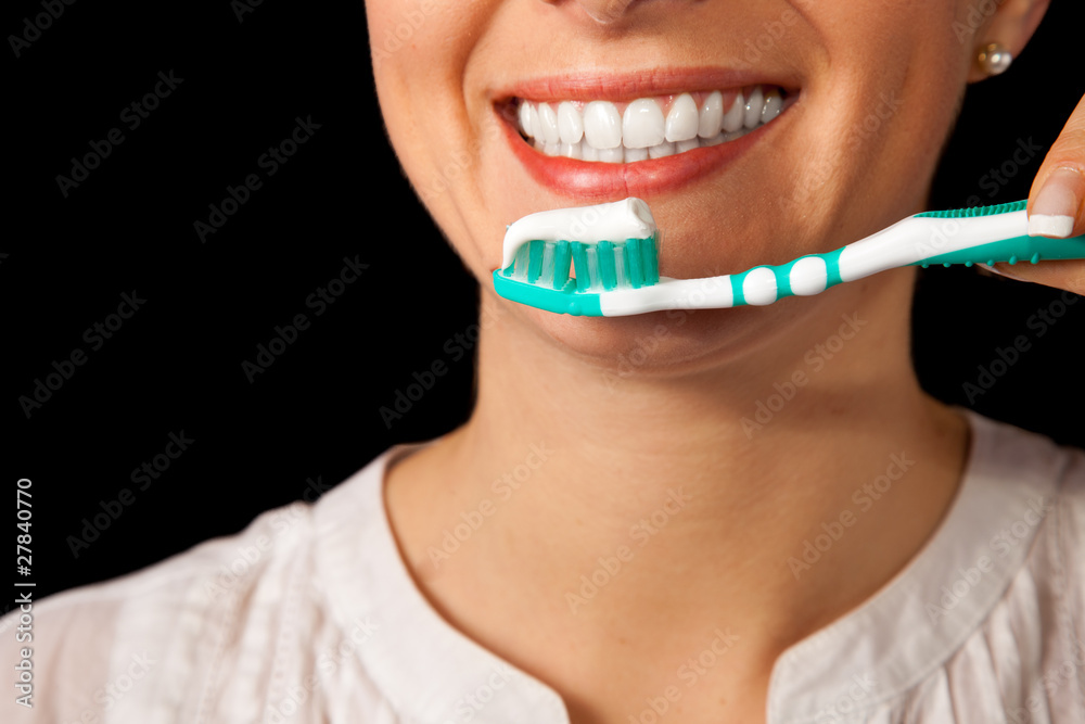 Woman healthy teeth closeup with toothbrush on black background Woman healthy teeth closeup with toothbrush on black background