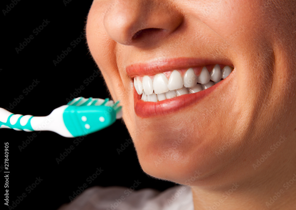 Fototapeta premium Woman healthy teeth closeup with toothbrush on black background
