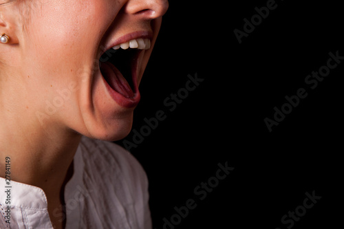 Fotografie Yelling woman mouth closeup
