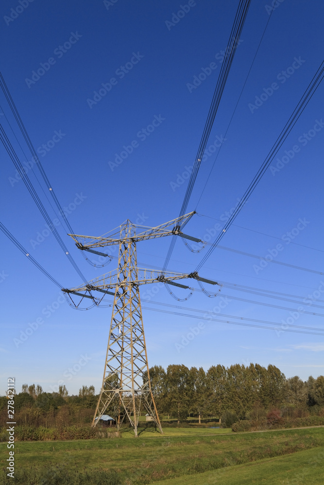 Electricity pylon aginst a blue sky