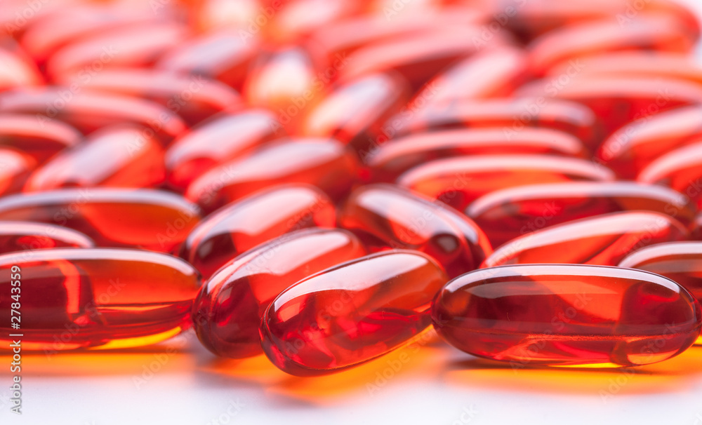 Red capsules on white background Red capsules on white background
