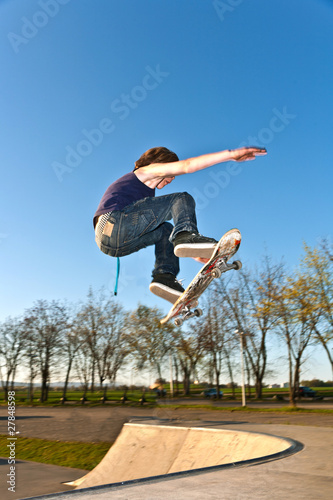 boy going airborne with the skate board