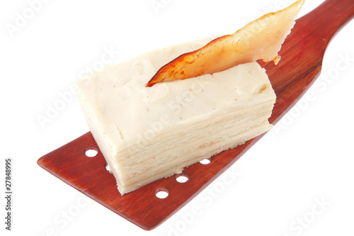 cream cake on wooden spatula