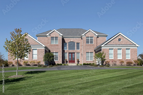 Large brick home with red door