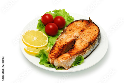 fish steak with vegetables on white background