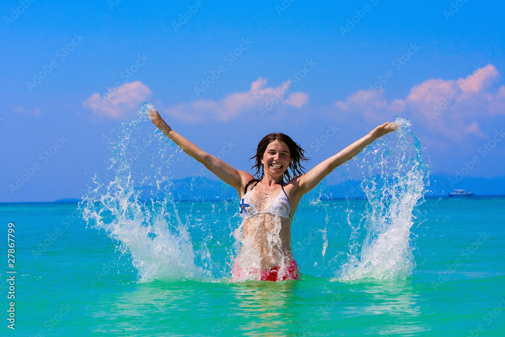 Young woman plays in water