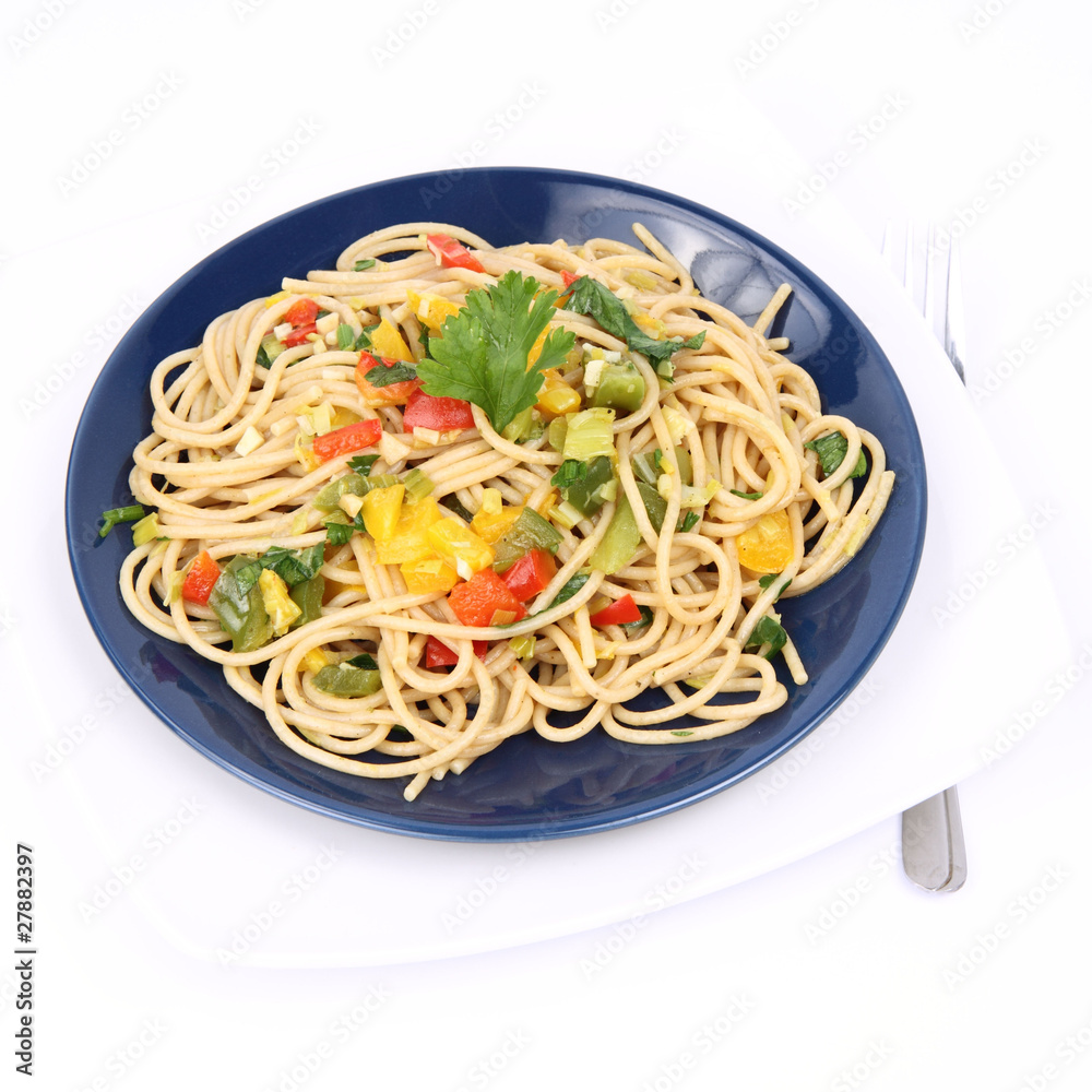 Spaghetti with vegetables on a plate on white background
