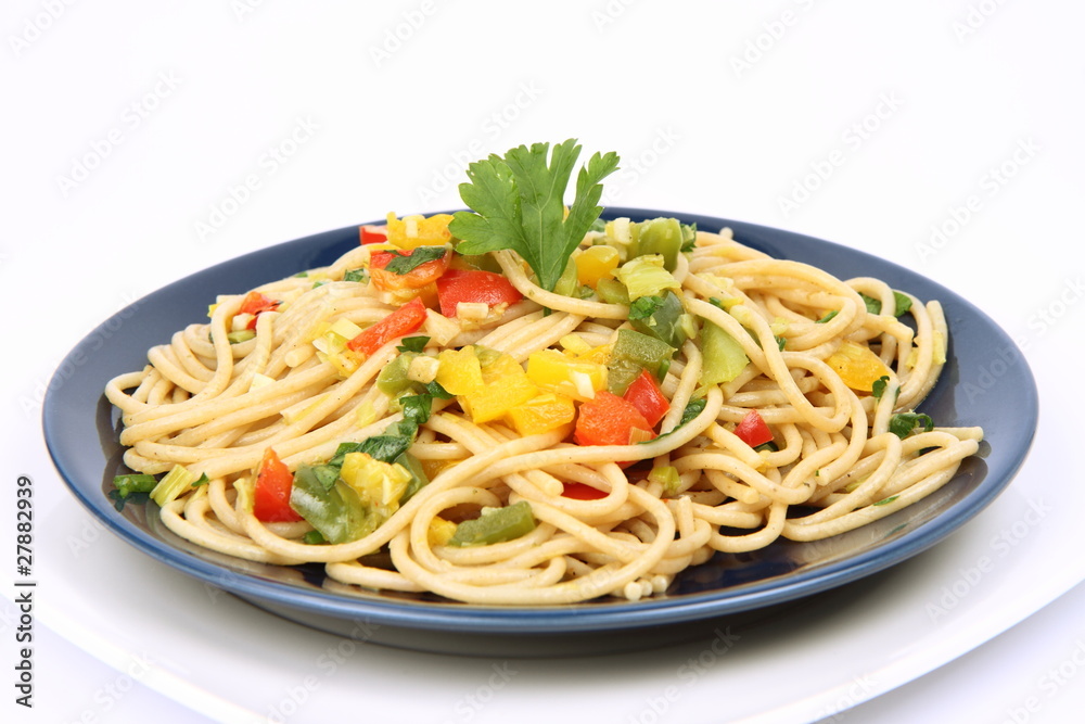 Spaghetti with vegetables on a plate on white background Spaghetti with vegetables on a plate on white background
