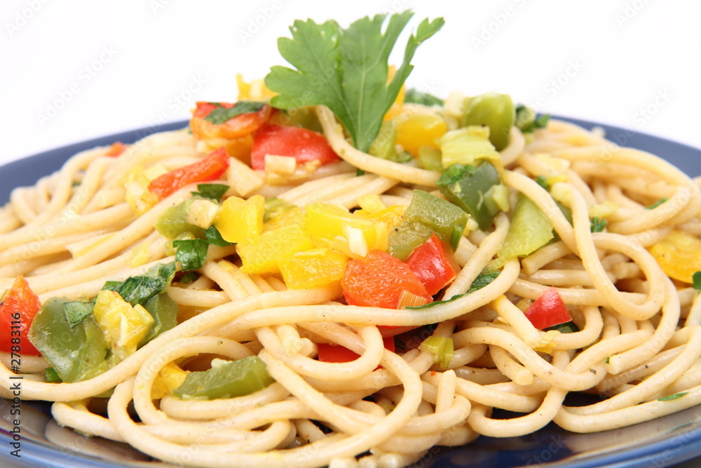 Spaghetti with vegetables on a plate in close up Spaghetti with vegetables on a plate in close up