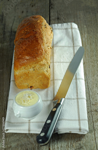 English granary loaf on towel with serrated bread knife photo