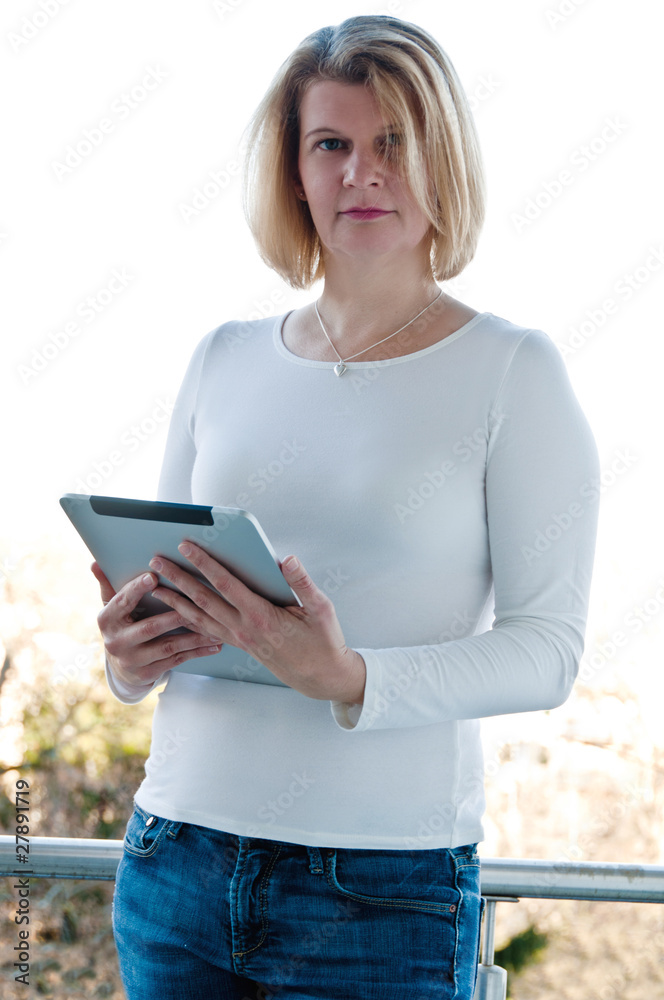 Woman holding a touchscreen table Woman holding a touchscreen table