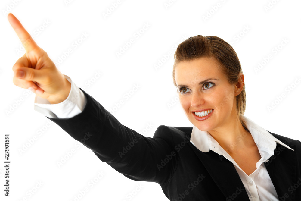 Smiling modern business woman pointing finger in corner Smiling modern business woman pointing finger in corner