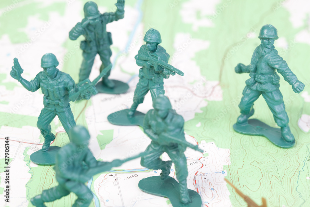 Plastic Army Men Fighting on Topographic Map Plastic Army Men Fighting on Topographic Map