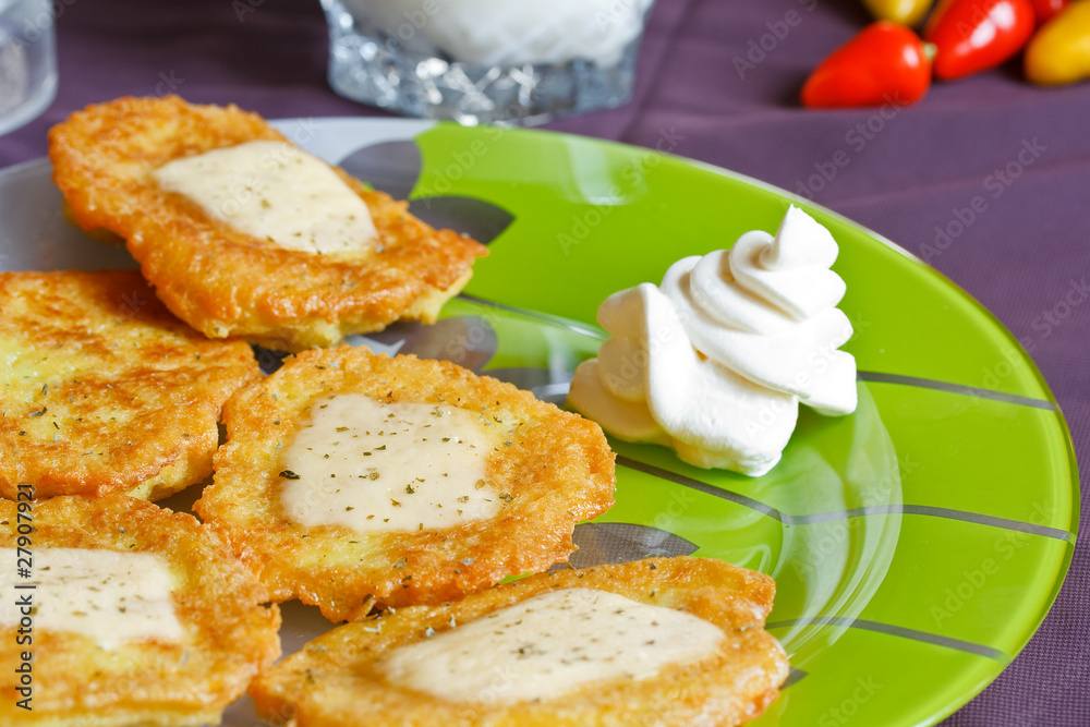 potato pancakes with cheese and sour cream
