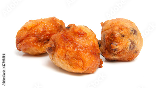 Thee Dutch donut also known as oliebollen over white background photo