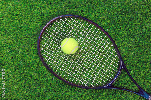 Tennis raquet and ball on grass © RTimages