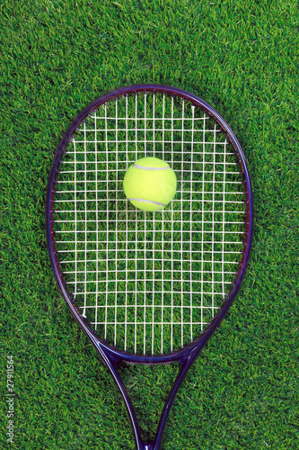 Tennis raquet and ball on grass © RTimages