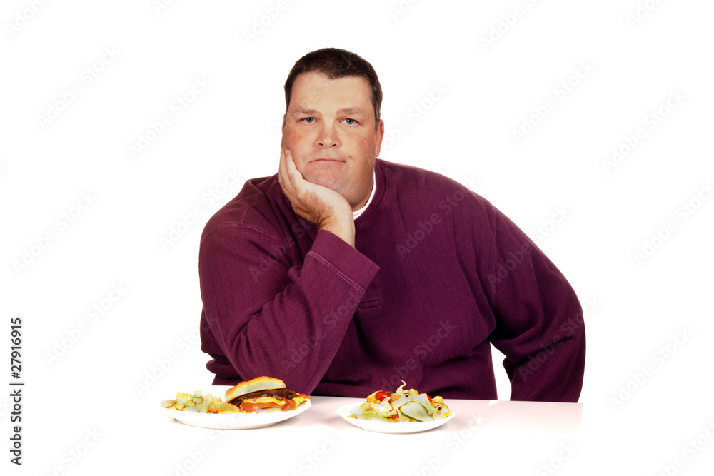 man thinking what to eat between a cheeseburger meal and a salad man thinking what to eat between a cheeseburger meal and a salad