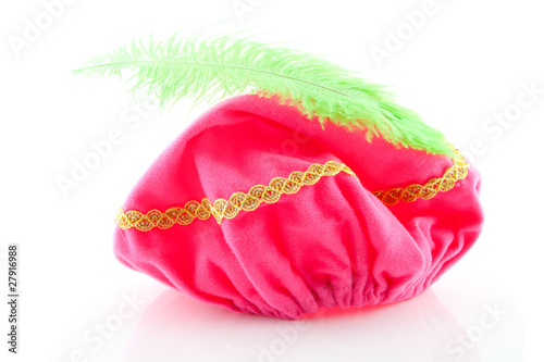 pink hat with green feather of Zwarte Piet over white background