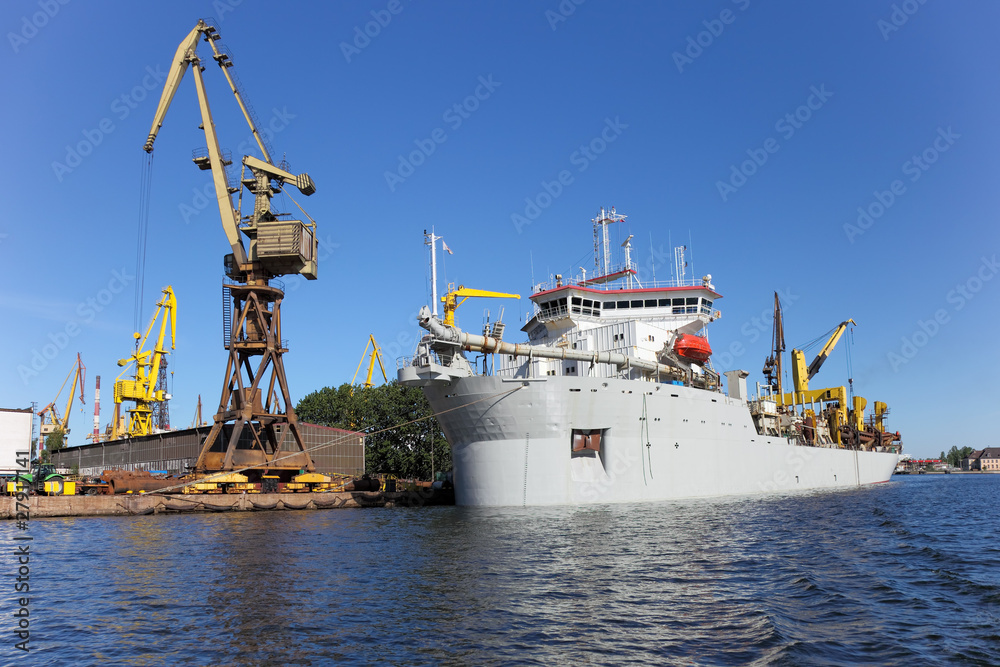 Obraz premium Dredging ship berthed at the wharf port in Gdansk, Poland.