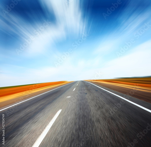 Asphalt blurry road and sky with blurry clouds © Dudarev Mikhail