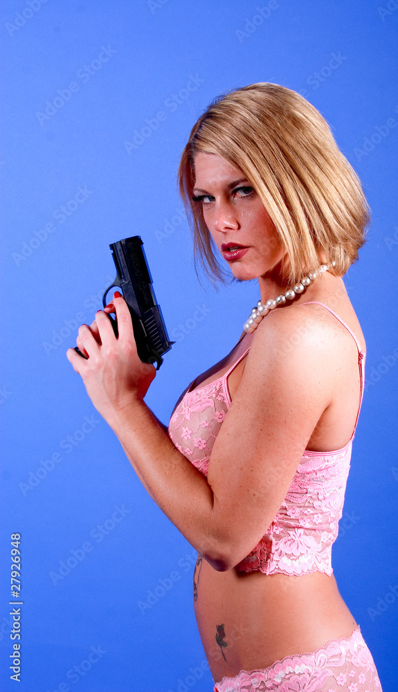 Sexy busty model with a gun Sexy busty model with a gun
