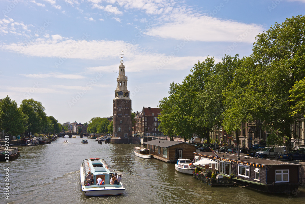 Amsterdam, Netherlands, Montelbaan Tower and canal cruise boat