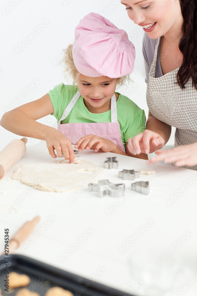 Cute daughter and her beautiful mother making cookies