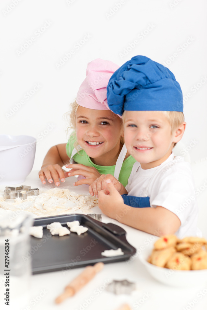 Two little chefs preparing cookies in the kitchen Two little chefs preparing cookies in the kitchen