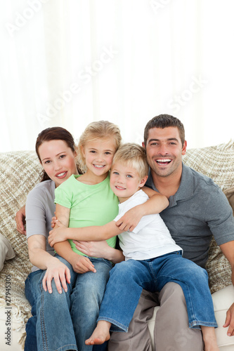 Joyful family sitting on the sofa