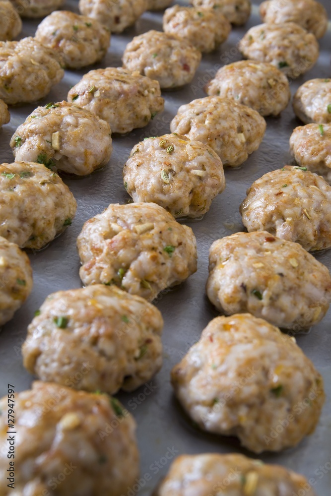 tray of cooked meatballs on a baking sheet tray of cooked meatballs on a baking sheet