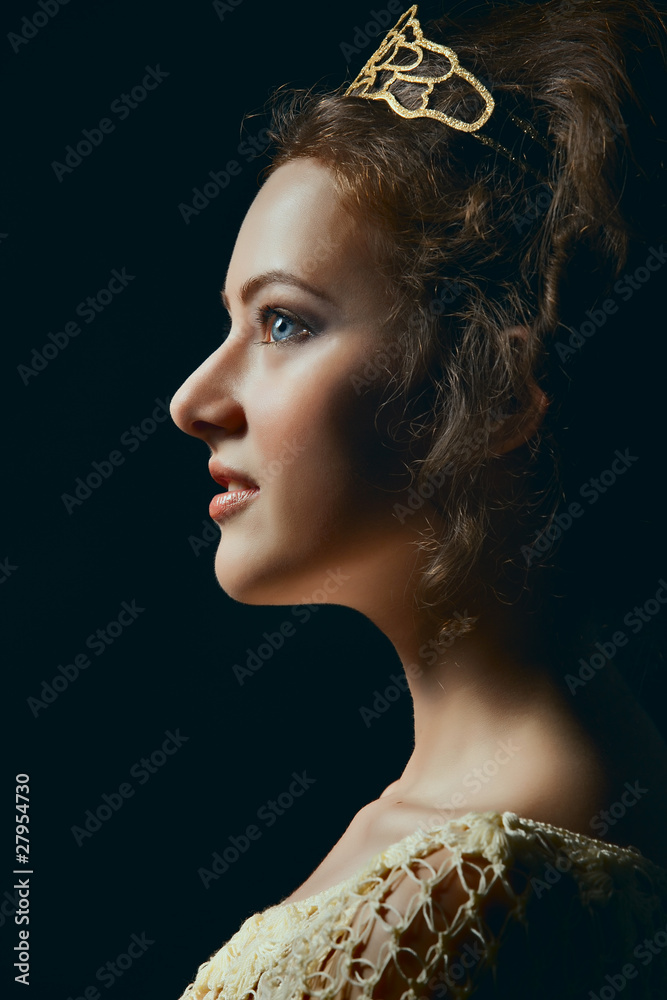 Profile of young woman on black background