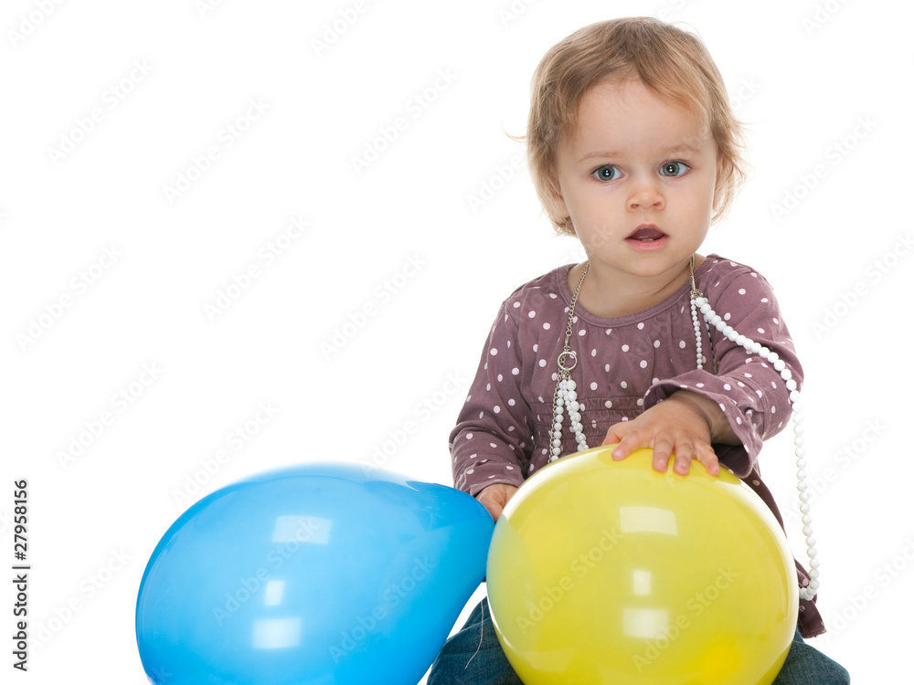 Little girl holding yellow and blue balloons Little girl holding yellow and blue balloons