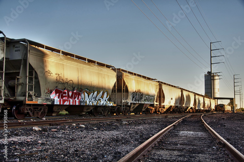 Urban landscape photo of train cargo with graffiti.