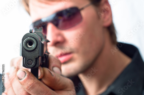 Man aiming with pistol wearing sunglasses