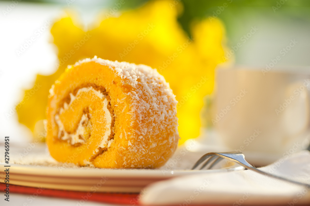Orange biscuit roll with a cup of coffee