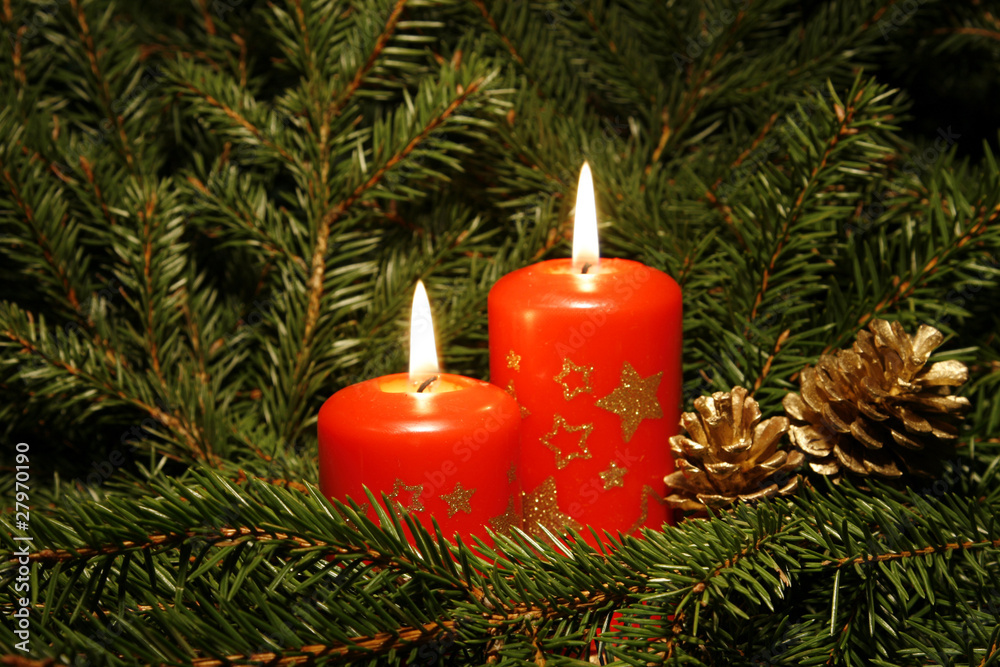 Two candles burning amongst twigs of the spruce Two candles burning amongst twigs of the spruce