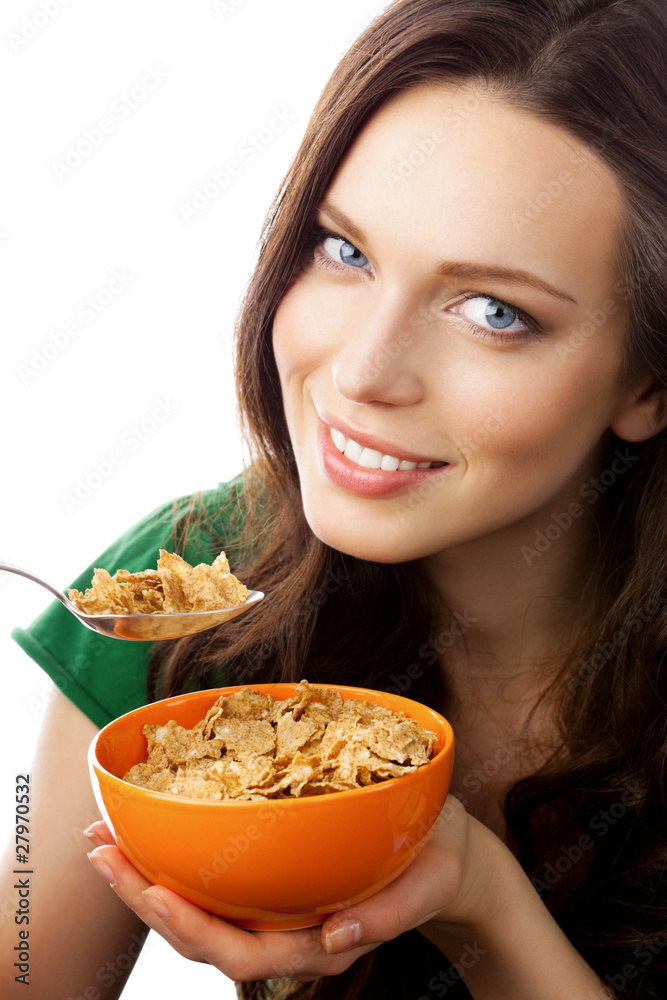 Portrait of woman eating muesli or cornflakes, isolated Portrait of woman eating muesli or cornflakes, isolated