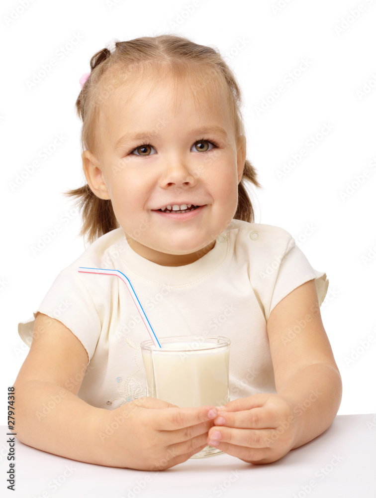 Little girl drinks milk using drinking straw Little girl drinks milk using drinking straw