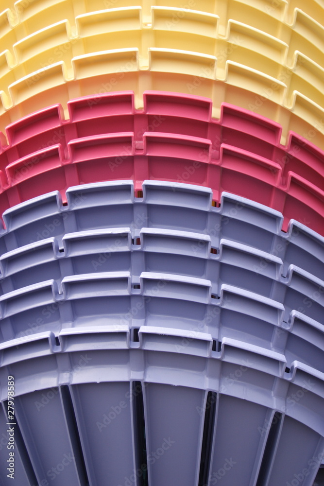 a stack of colorful garden chairs a stack of colorful garden chairs