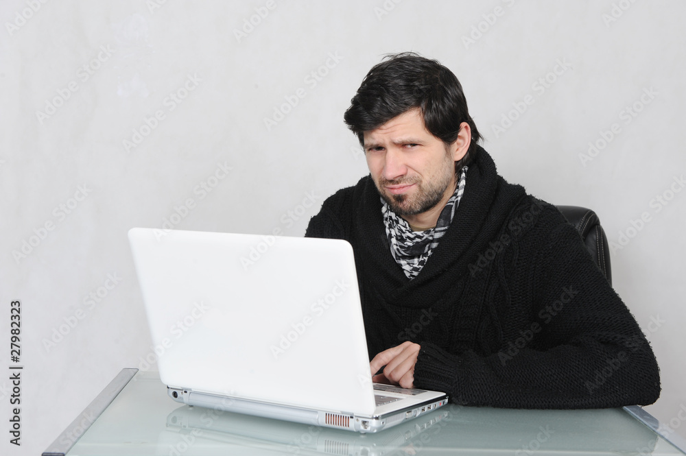 young unsatisfied adult with his computer young unsatisfied adult with his computer