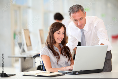 Manager and office worker in wheelchair